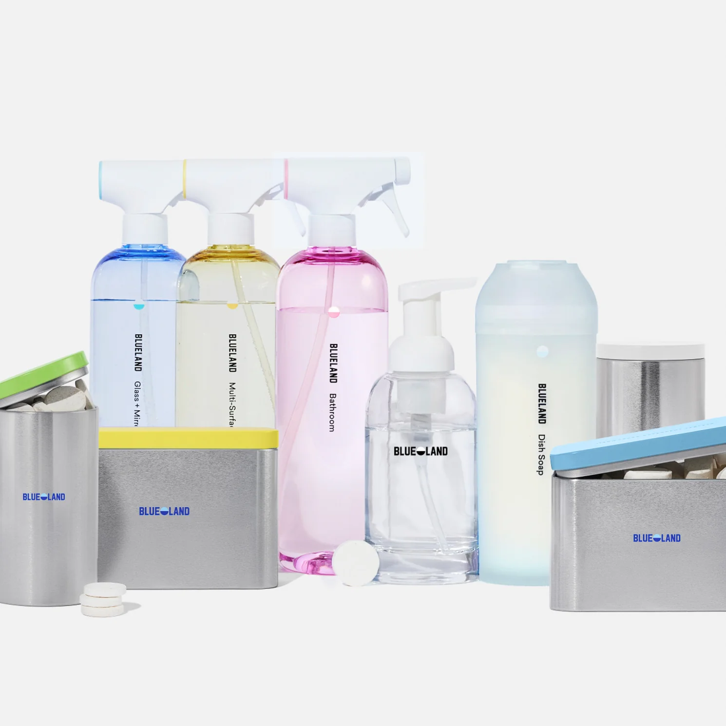 A collection of BLUELAND cleaning products, including spray bottles in different colors, foaming hand soap, tablet refills, powder containers, a scrubbing brush, and a blue cleaning cloth, arranged on a white background.